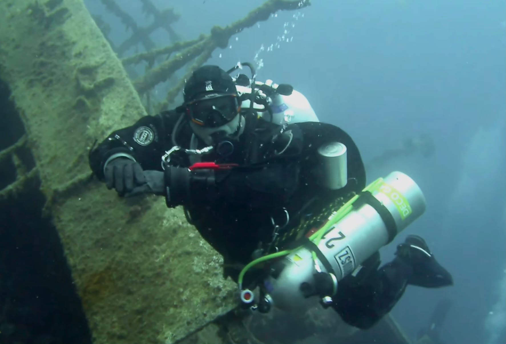 Mariusz Ciupa at the Teti wreck off Vis, Croatia, carrying a decompression cylinder and diving a dry suit