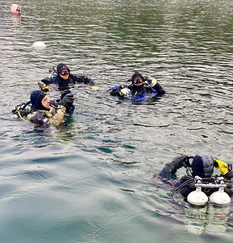 Diver at the surface at Vobster Quay, mask above the waterline